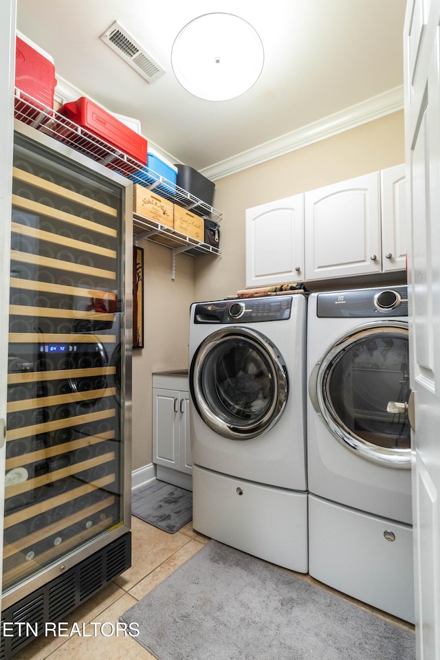 1155 Evelyn Mae Way, Knoxville, TN 37923 - washroom with crown molding, wine cooler, washing machine and dryer, cabinet space, and light tile patterned flooring