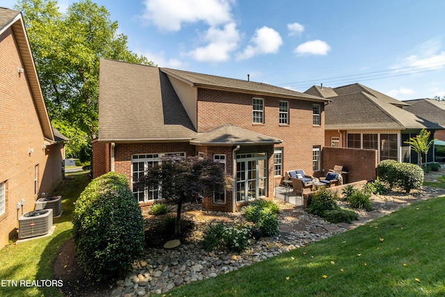 1155 Evelyn Mae Way, Knoxville, TN 37923 - back of house featuring brick siding, an outdoor hangout area, a shingled roof, a patio, and a yard