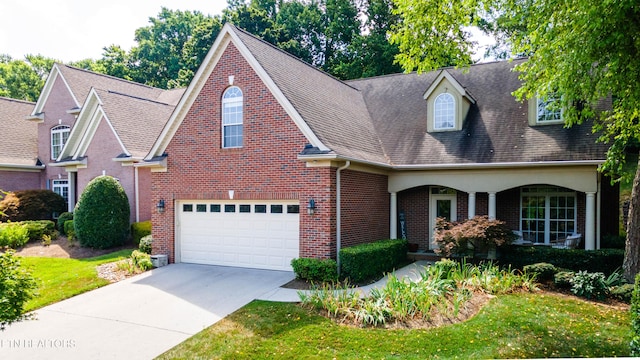 1155 Evelyn Mae Way, Knoxville, TN 37923 - view of front of home with an attached garage, driveway, brick siding, a shingled roof, and a front lawn
