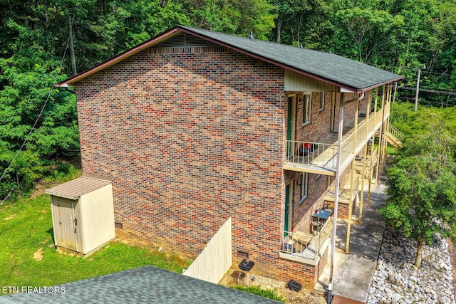 2810 Daybreak Way, Strawberry Plains, TN 37871 - view of property exterior with a balcony, a storage unit, brick siding, and a patio area