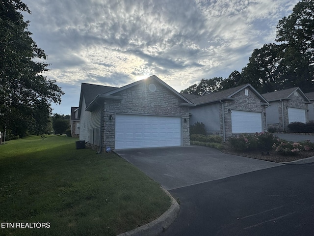 101 Pear Tree Ln, Loudon, TN 37774 - ranch-style house featuring stone siding, a front lawn, an attached garage, and driveway