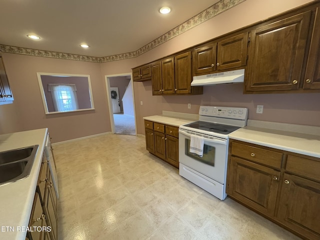 101 Pear Tree Ln, Loudon, TN 37774 - kitchen with white range with electric stovetop, under cabinet range hood, light countertops, recessed lighting, and light flooring