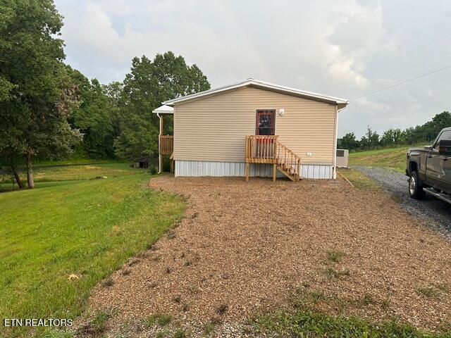 167 Loftis Rd, Parrottsville, TN 37843 - back of property featuring a lawn and gravel driveway