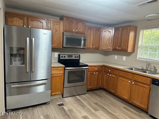 167 Loftis Rd, Parrottsville, TN 37843 - kitchen with appliances with stainless steel finishes, light countertops, brown cabinets, and light wood-style floors