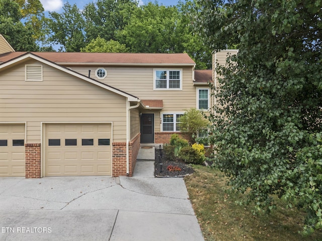 8600 Olde Colony Trl Unit 106, Knoxville, TN 37923 - view of front of house with driveway, brick siding, and a garage