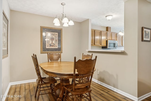8600 Olde Colony Trl Unit 106, Knoxville, TN 37923 - dining area with wood finished floors, a chandelier, and a textured ceiling
