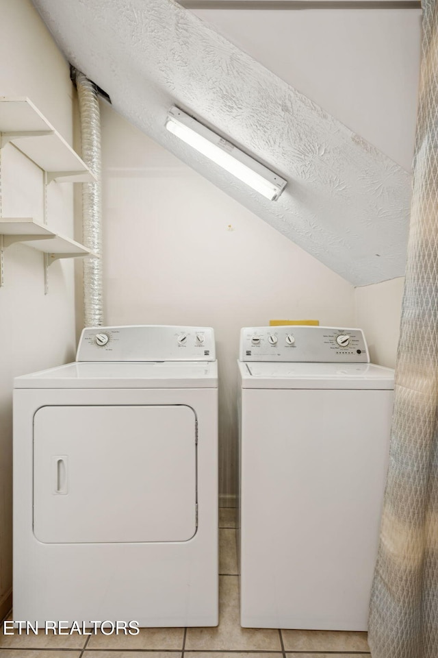 8600 Olde Colony Trl Unit 106, Knoxville, TN 37923 - laundry area featuring independent washer and dryer, light tile patterned flooring, and a textured ceiling