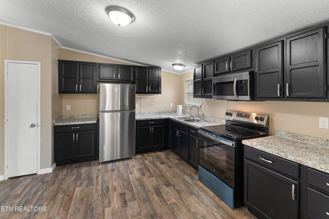 130 Hidden Estates Way, Newport, TN 37821 - kitchen featuring appliances with stainless steel finishes, dark cabinetry, dark wood-style floors, a textured ceiling, and light countertops