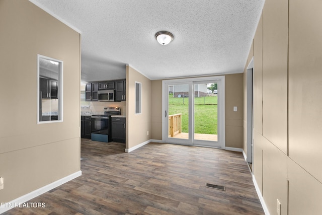 130 Hidden Estates Way, Newport, TN 37821 - kitchen with range with electric cooktop, stainless steel microwave, dark wood finished floors, a textured ceiling, and dark cabinetry