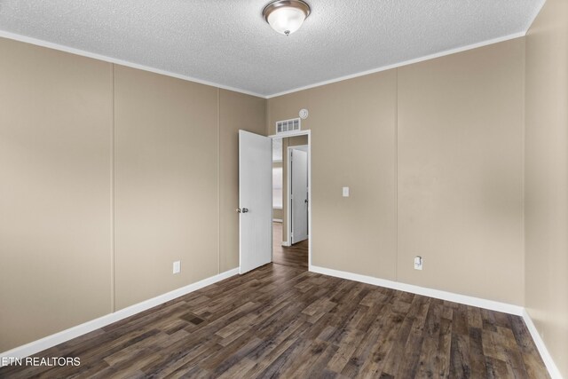130 Hidden Estates Way, Newport, TN 37821 - spare room with dark wood finished floors, a textured ceiling, ornamental molding, and a decorative wall
