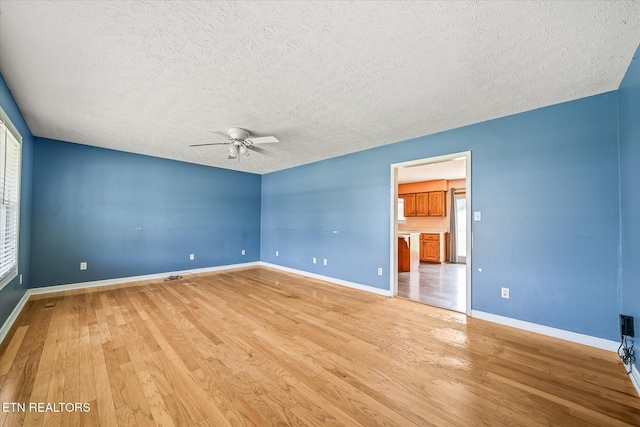 2019 Martha Washington Rd, Clarkrange, TN 38553 - empty room with a textured ceiling, light wood finished floors, and a ceiling fan