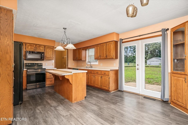 2019 Martha Washington Rd, Clarkrange, TN 38553 - kitchen with black appliances, light countertops, a textured ceiling, dark wood-type flooring, and a center island