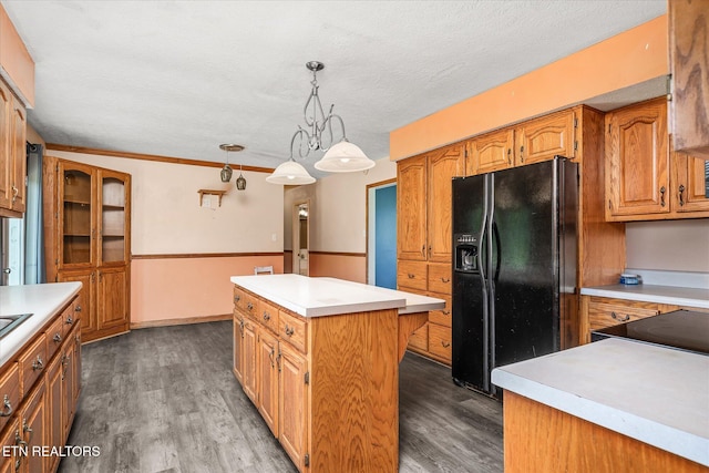 2019 Martha Washington Rd, Clarkrange, TN 38553 - kitchen with black fridge, a kitchen island, light countertops, wood finished floors, and a textured ceiling