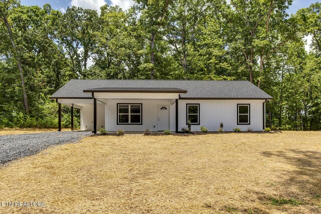 181 Lakeshore Ln, Decatur, TN 37322 - view of front of home featuring a shingled roof, driveway, an attached carport, and view of scattered trees