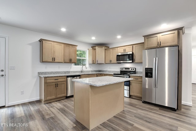 181 Lakeshore Ln, Decatur, TN 37322 - kitchen featuring appliances with stainless steel finishes, light wood-style flooring, a center island, recessed lighting, and light stone countertops