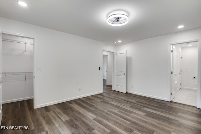 181 Lakeshore Ln, Decatur, TN 37322 - unfurnished bedroom featuring wood finished floors, a spacious closet, ensuite bathroom, a closet, and recessed lighting