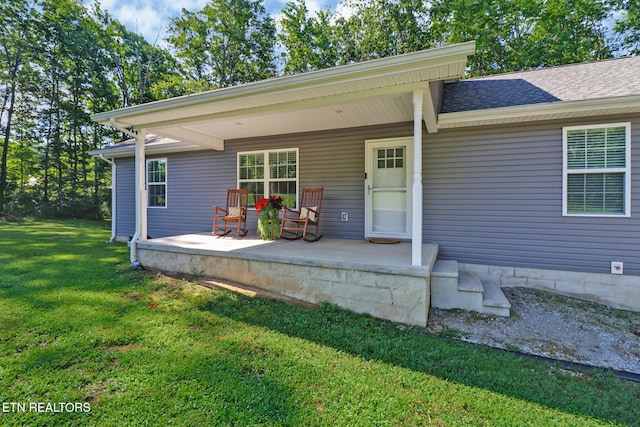 2296 Memory Garden Rd, Jamestown, TN 38556 - view of exterior entry with a yard, a porch, and roof with shingles