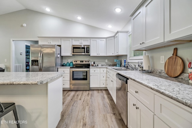 2296 Memory Garden Rd, Jamestown, TN 38556 - kitchen with appliances with stainless steel finishes, light wood-style flooring, a breakfast bar, white cabinetry, and recessed lighting