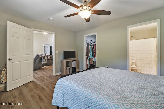 2296 Memory Garden Rd, Jamestown, TN 38556 - bedroom with wood finished floors, a spacious closet, a closet, connected bathroom, and ceiling fan
