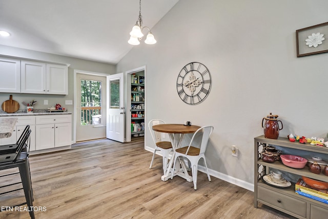 2296 Memory Garden Rd, Jamestown, TN 38556 - dining room featuring lofted ceiling, light wood finished floors, and a chandelier