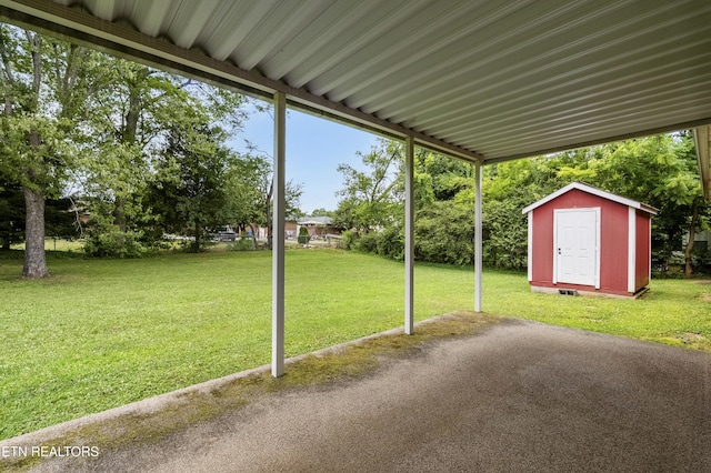 776 Hamilton St, Alcoa, TN 37701 - view of green lawn featuring a storage unit and a patio