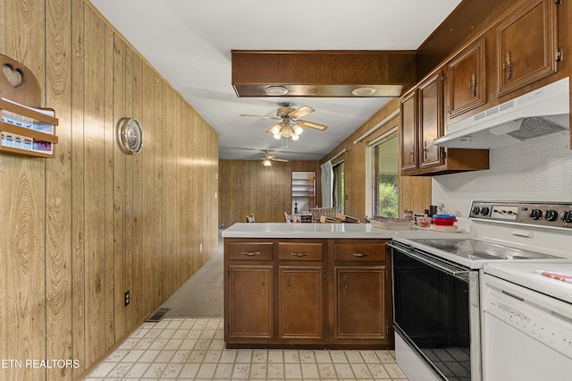 776 Hamilton St, Alcoa, TN 37701 - kitchen featuring electric stove, under cabinet range hood, wooden walls, white dishwasher, and a peninsula