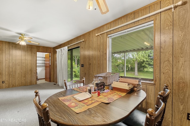 776 Hamilton St, Alcoa, TN 37701 - carpeted dining area featuring a ceiling fan and wooden walls