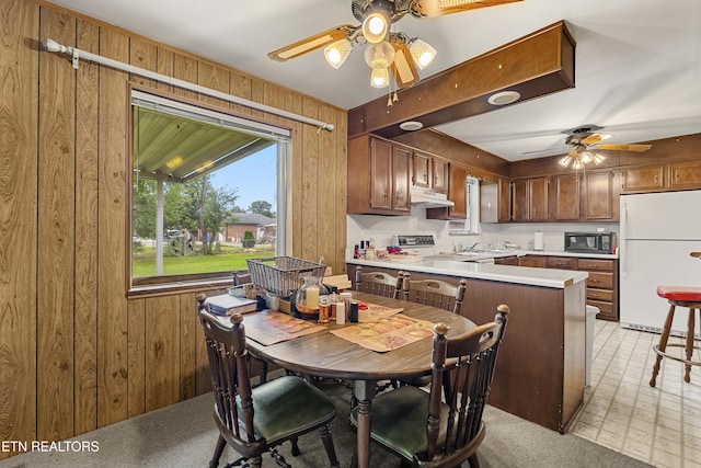 776 Hamilton St, Alcoa, TN 37701 - dining area with wood walls, a ceiling fan, and light flooring
