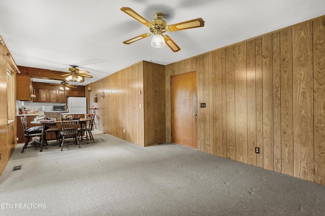 776 Hamilton St, Alcoa, TN 37701 - carpeted dining area with a ceiling fan and wood walls