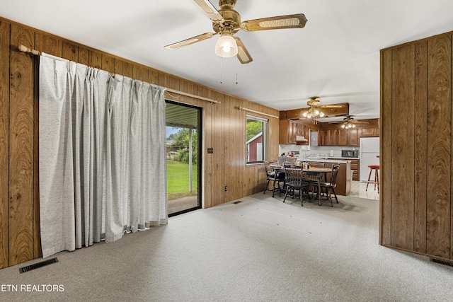 776 Hamilton St, Alcoa, TN 37701 - dining space featuring ceiling fan, light colored carpet, and wood walls