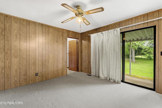 776 Hamilton St, Alcoa, TN 37701 - spare room featuring carpet flooring, wood walls, and ceiling fan