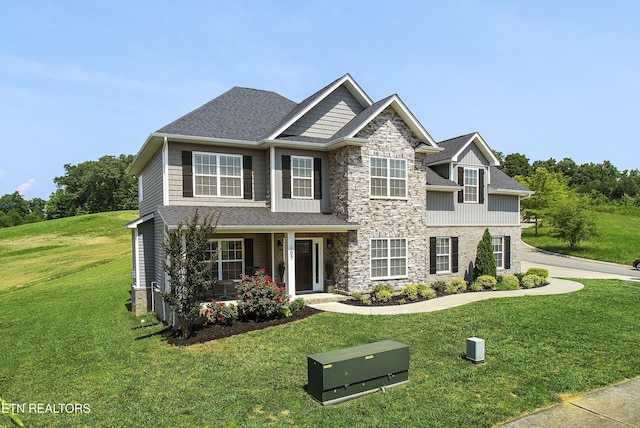 107 Cedarberry St, Oak Ridge, TN 37830 - craftsman house with stone siding, a front yard, covered porch, and roof with shingles