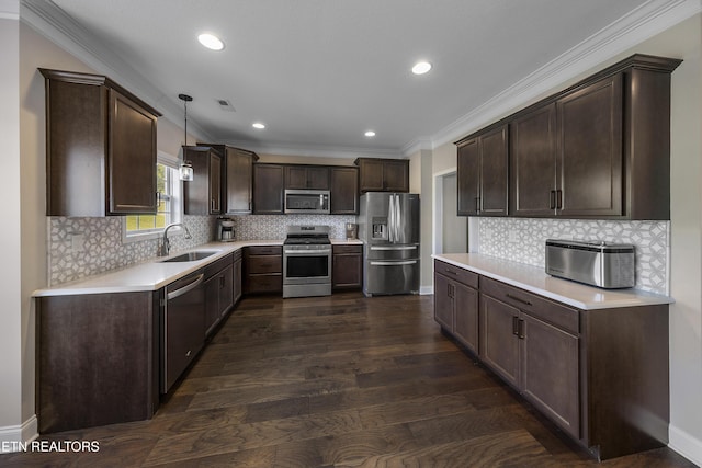 107 Cedarberry St, Oak Ridge, TN 37830 - kitchen with appliances with stainless steel finishes, dark brown cabinetry, light countertops, dark wood-style flooring, and hanging light fixtures