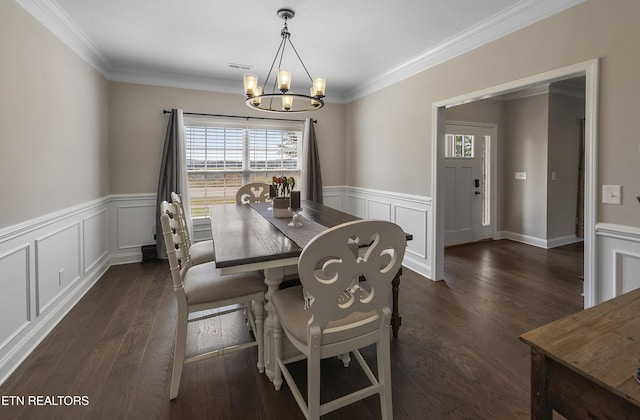 107 Cedarberry St, Oak Ridge, TN 37830 - dining space with a chandelier, wainscoting, a decorative wall, dark wood-style floors, and crown molding