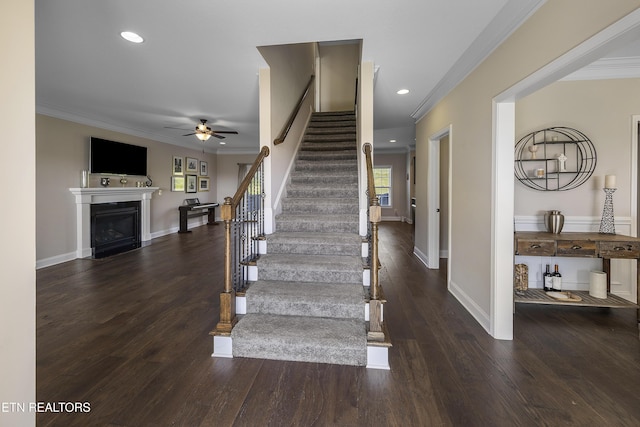 107 Cedarberry St, Oak Ridge, TN 37830 - staircase featuring ornamental molding, a ceiling fan, a fireplace, wood finished floors, and recessed lighting
