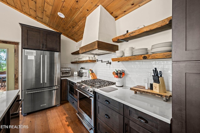 3721 Clabo Mountain Ln, Sevierville, TN 37862 - kitchen with premium appliances, open shelves, custom exhaust hood, wood-type flooring, and decorative backsplash