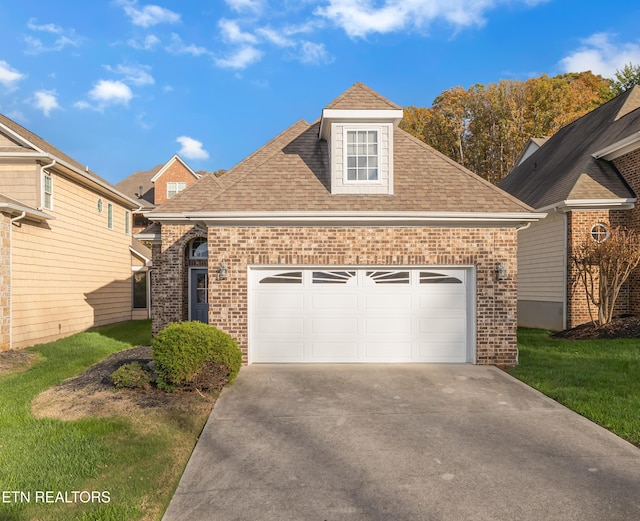 1036 Gothic Manor Way, Knoxville, TN 37923 - traditional-style home featuring brick siding, concrete driveway, roof with shingles, and a front lawn