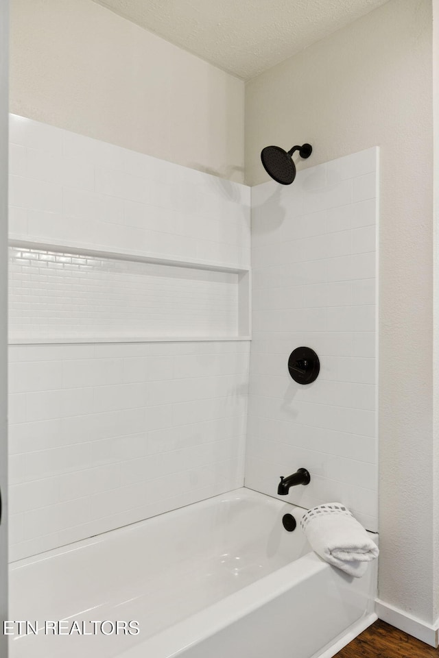 142 Campbell Way, Newport, TN 37821 - bathroom with washtub / shower combination, wood finished floors, and a textured ceiling