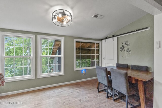 149 Giles Rd, Cosby, TN 37722 - dining area featuring lofted ceiling, wood finished floors, and a barn door