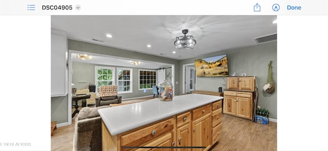 149 Giles Rd, Cosby, TN 37722 - kitchen with light wood finished floors, recessed lighting, a kitchen island, light countertops, and a chandelier