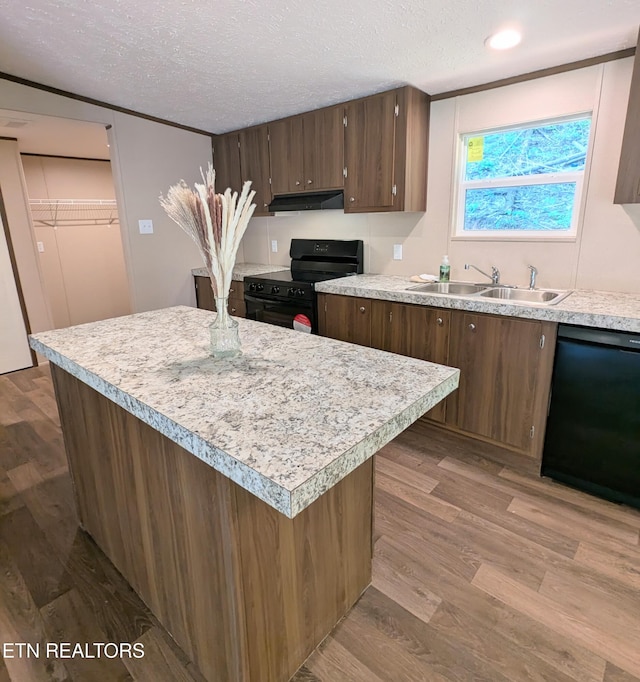 1431 Blue Springs Way, Newport, TN 37821 - kitchen with black appliances, under cabinet range hood, light countertops, a textured ceiling, and wood finished floors