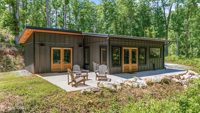 11325 New Highway 68, Tellico Plains, TN 37385 - back of property featuring board and batten siding, a patio, and french doors