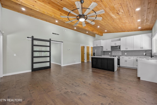 11325 New Highway 68, Tellico Plains, TN 37385 - kitchen with appliances with stainless steel finishes, a wood ceiling with exposed beams, a barn door, recessed lighting, and a kitchen island