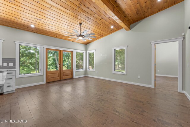 11325 New Highway 68, Tellico Plains, TN 37385 - unfurnished living room featuring wood ceiling, vaulted ceiling, healthy amount of natural light, a ceiling fan, and dark wood-type flooring