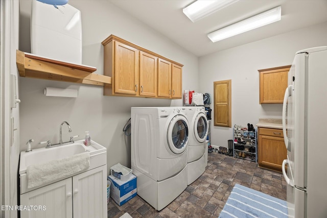 61 Brim Ln, Hilham, TN 38568 - laundry area featuring washer and clothes dryer, stone finish floors, and cabinet space