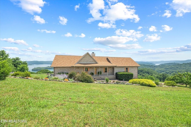61 Brim Ln, Hilham, TN 38568 - single story home with a front lawn, a chimney, a porch, and brick siding