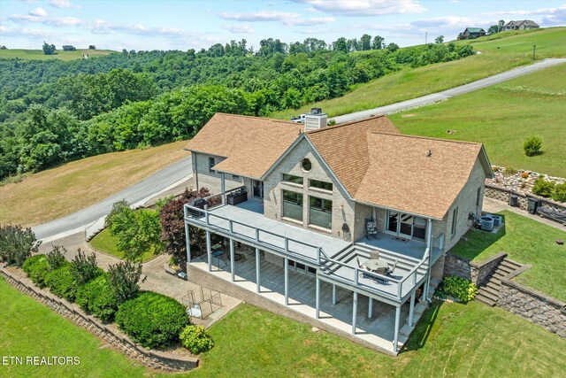 61 Brim Ln, Hilham, TN 38568 - rear view of house featuring a patio area, a deck, a shingled roof, and a yard