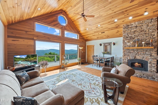 61 Brim Ln, Hilham, TN 38568 - living room with high vaulted ceiling, wood finished floors, a stone fireplace, wooden ceiling, and wooden walls