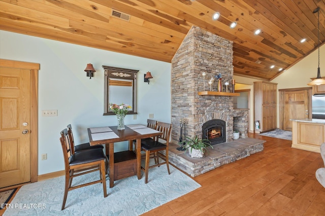 61 Brim Ln, Hilham, TN 38568 - dining area featuring light wood-style floors, wood ceiling, a stone fireplace, and high vaulted ceiling