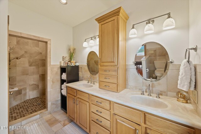 61 Brim Ln, Hilham, TN 38568 - bathroom featuring tile walls, double vanity, walk in shower, tile patterned floors, and wainscoting